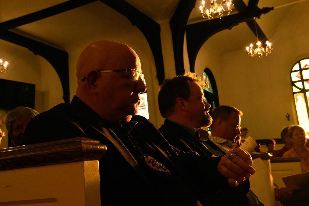 Columbia Police Chief Ken Burton sits in a pew